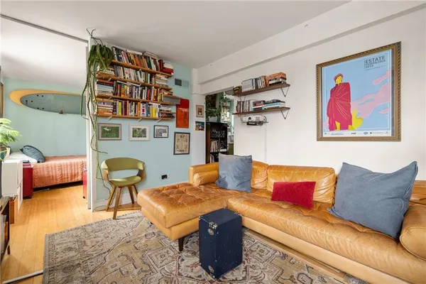 a living room with furniture and a book shelf