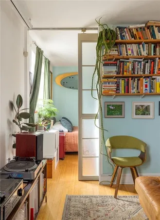 a bedroom with furniture and a book shelf