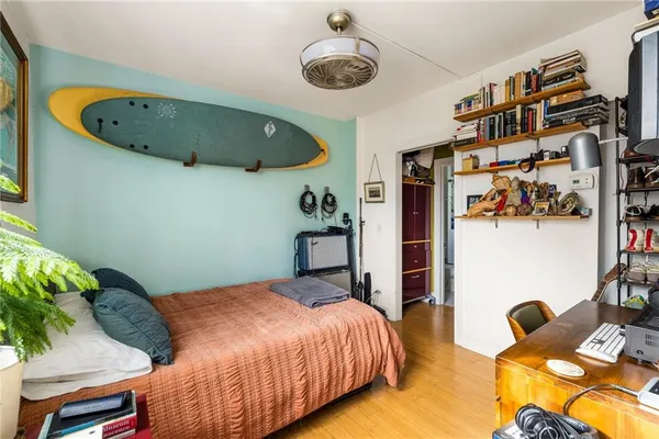 a bedroom with a bed and a chair