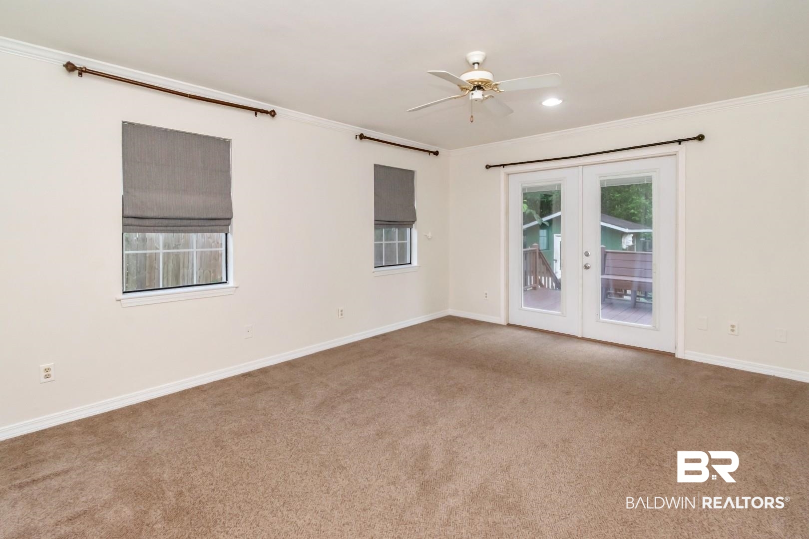 33 Lancaster Road Mobile, AL 36608 - Photo 14 of 40 Unfurnished room with french doors, ornamental molding, carpet, a ceiling fan, and baseboards
