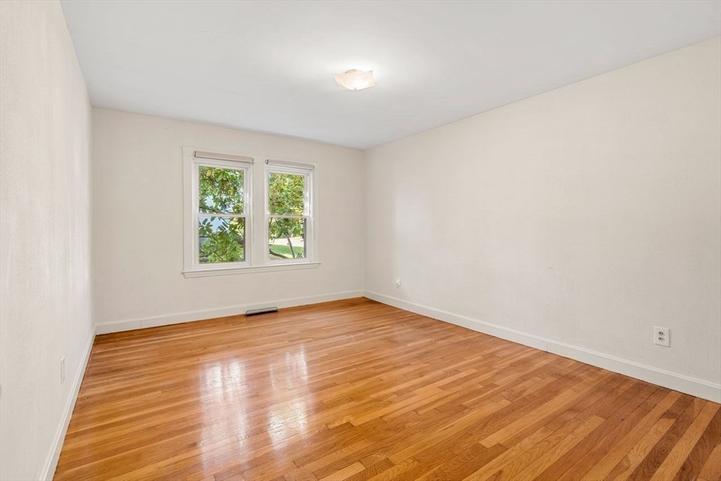 9 Pearson Street Beverly, MA 01915 - Photo 19 of 41 an empty room with wooden floor and windows