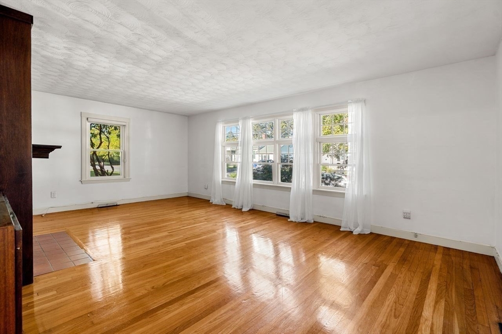9 Pearson Street Beverly, MA 01915 - Photo 20 of 41 a view of an empty room with a window and wooden floor