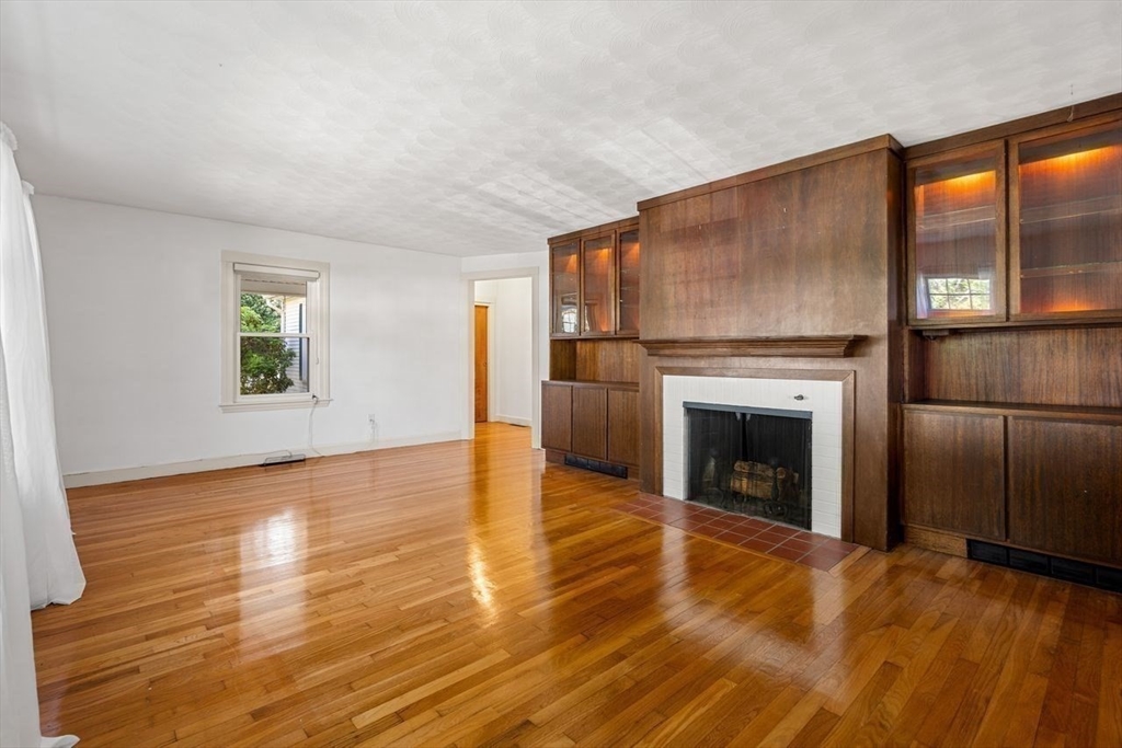 9 Pearson Street Beverly, MA 01915 - Photo 22 of 41 a view of a livingroom with an empty space and a fireplace