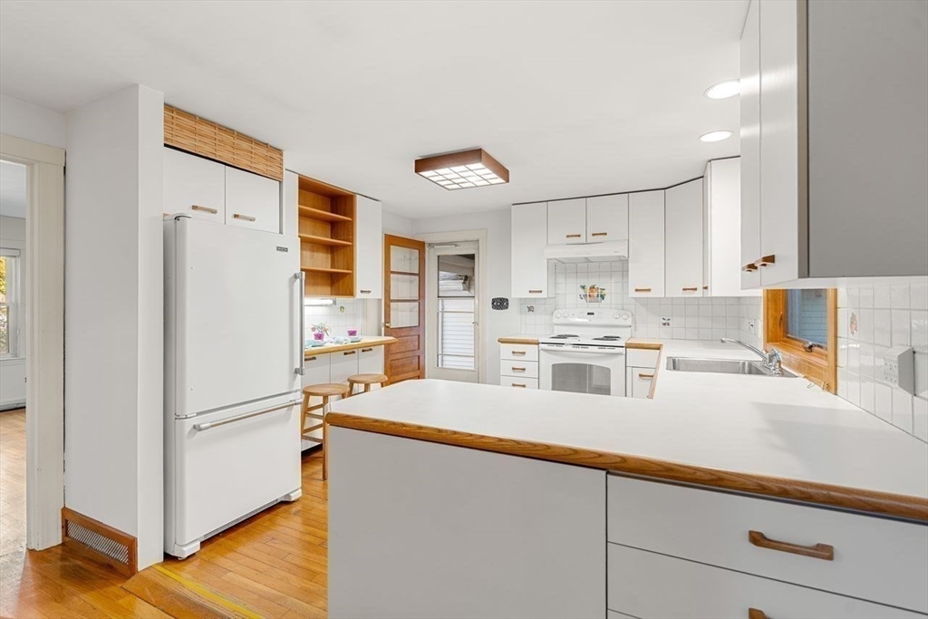 9 Pearson Street Beverly, MA 01915 - Photo 9 of 41 a kitchen with stainless steel appliances a refrigerator sink and cabinets
