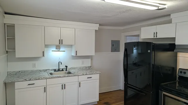 a kitchen with a refrigerator and cabinets