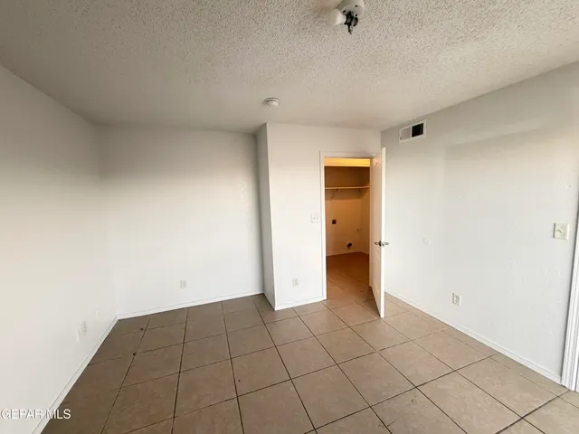 a view of an empty room and a window