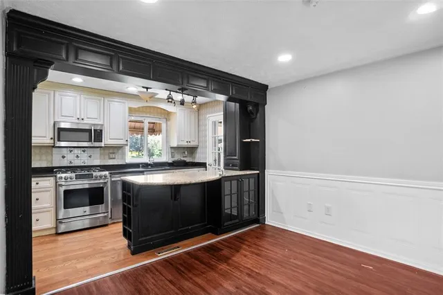 a kitchen with stainless steel appliances granite countertop a stove and a refrigerator