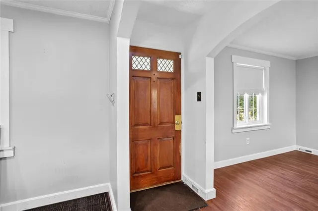 an empty room with windows closet and fireplace