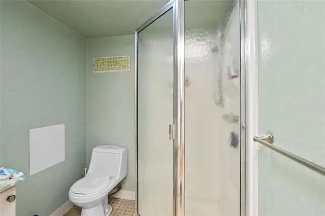 a white toilet sitting next to a bathroom sink