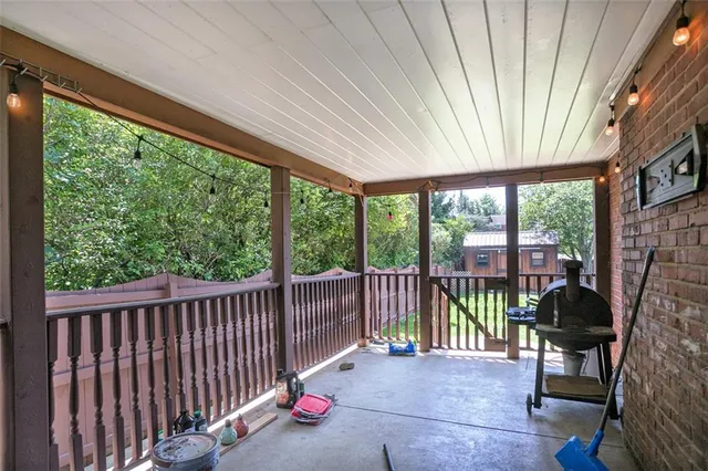 a view of a porch with furniture and backyard