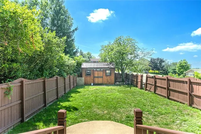 a view of a backyard with wooden fence