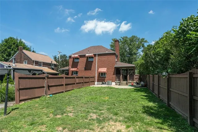 a front view of a house with a yard table and chairs