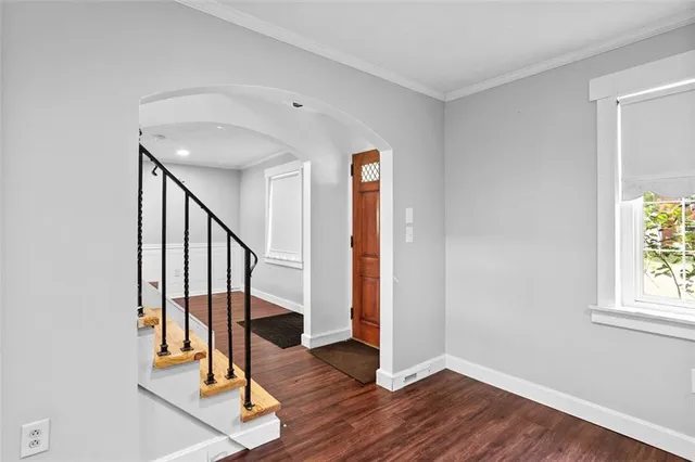 a view of an entryway with wooden floor