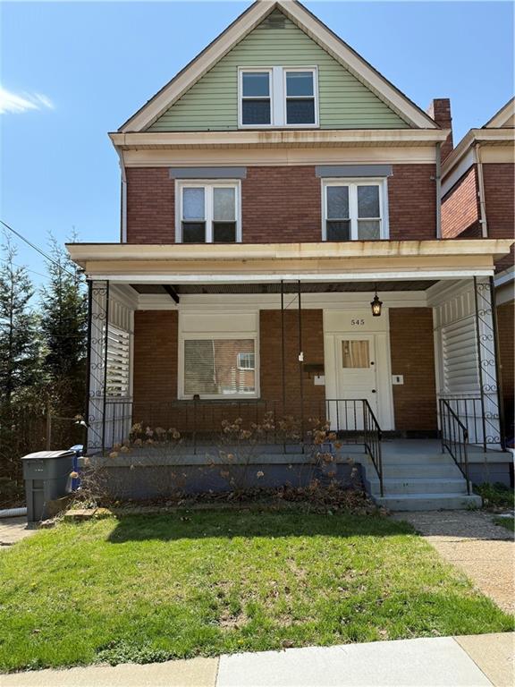 a front view of a house with a yard