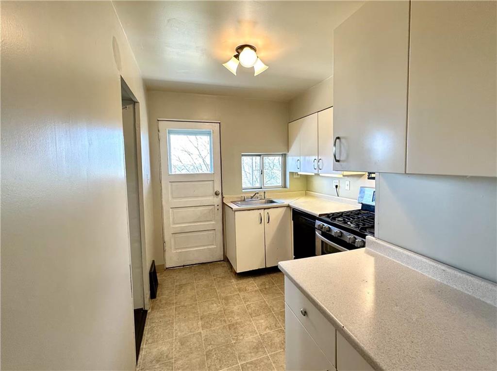 545 Forest Avenue Pittsburgh, PA 15202 - Photo 13 of 26 a kitchen with a sink a stove and cabinets