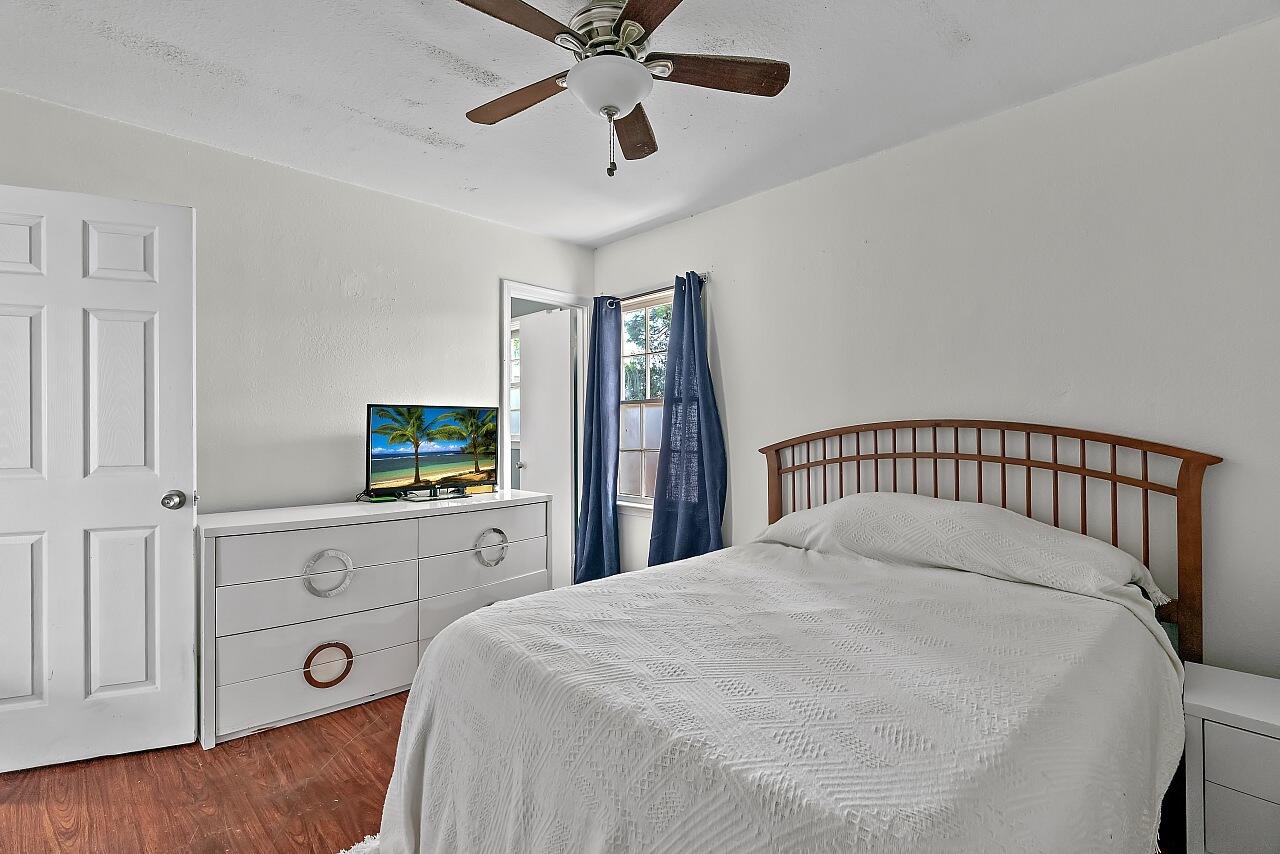481 Warren Street Sebastian, FL 32958 - Photo 15 of 33 a bedroom with a bed and a flat tv screen