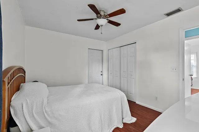 a bedroom with a bed and a ceiling fan