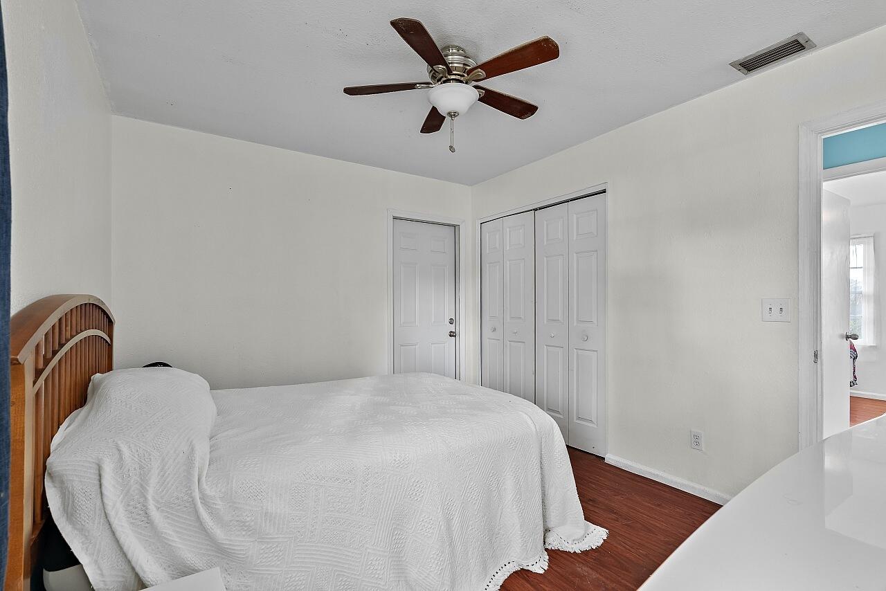 481 Warren Street Sebastian, FL 32958 - Photo 16 of 33 a bedroom with a bed and a ceiling fan