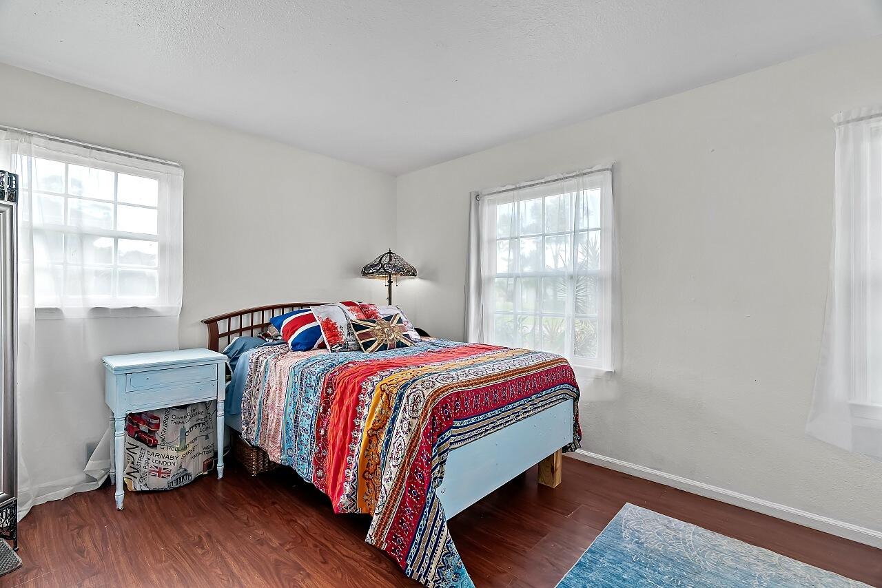 481 Warren Street Sebastian, FL 32958 - Photo 18 of 33 a bed sitting in a bedroom next to a window