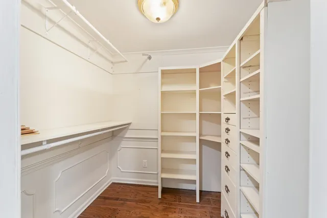 a view of walk in closet with empty racks