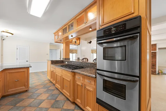 a kitchen with stainless steel appliances granite countertop a stove and a microwave