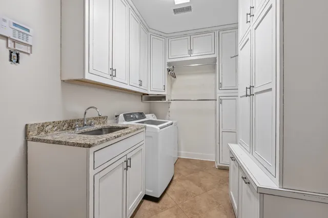 a kitchen with white cabinets and white appliances
