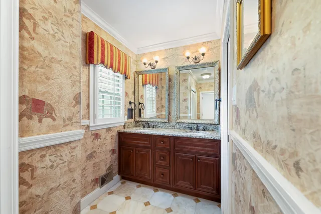 a bathroom with a granite countertop sink a large mirror and a bathtub
