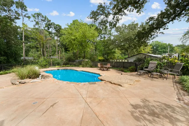 a view of a swimming pool with a patio
