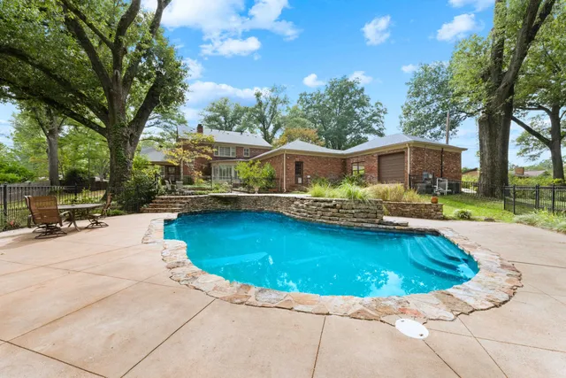 a view of a swimming pool with a patio