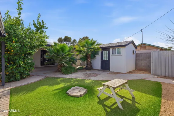 a view of a backyard with plants and patio