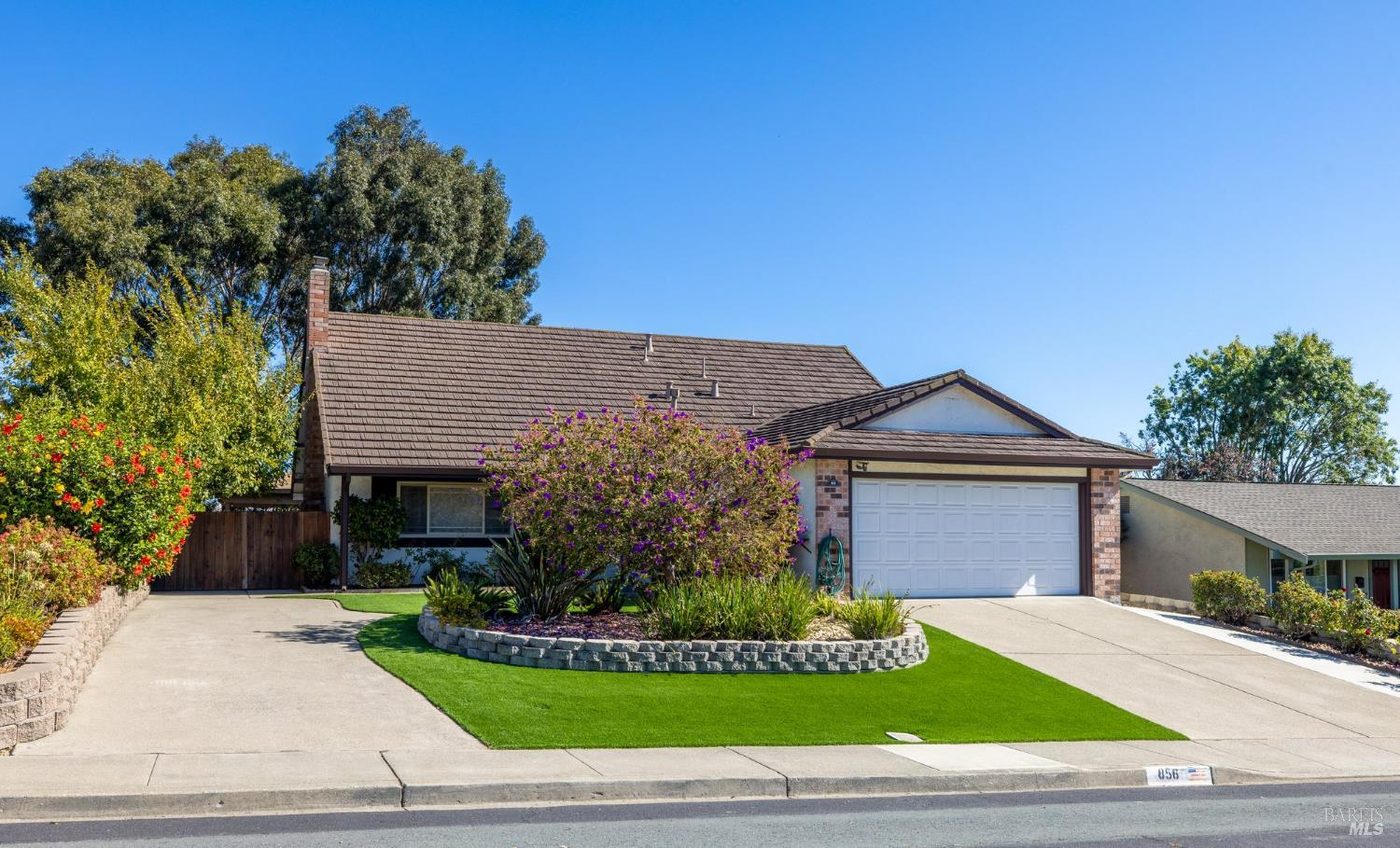 a front view of a house with a garden
