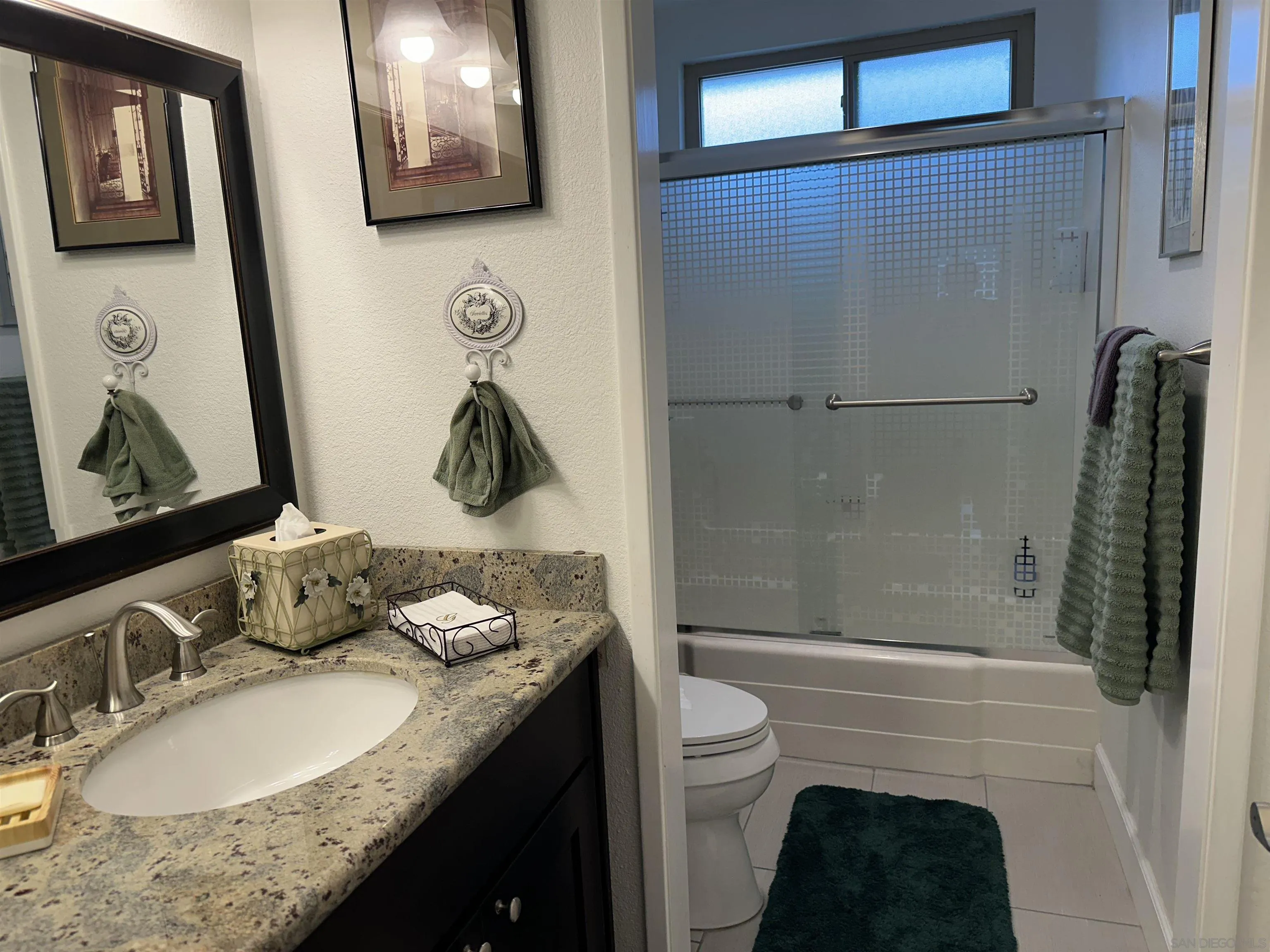 4318 Mirage Lane Oceanside, CA 92056 - Photo 14 of 17 a bathroom with a granite countertop sink a toilet and shower