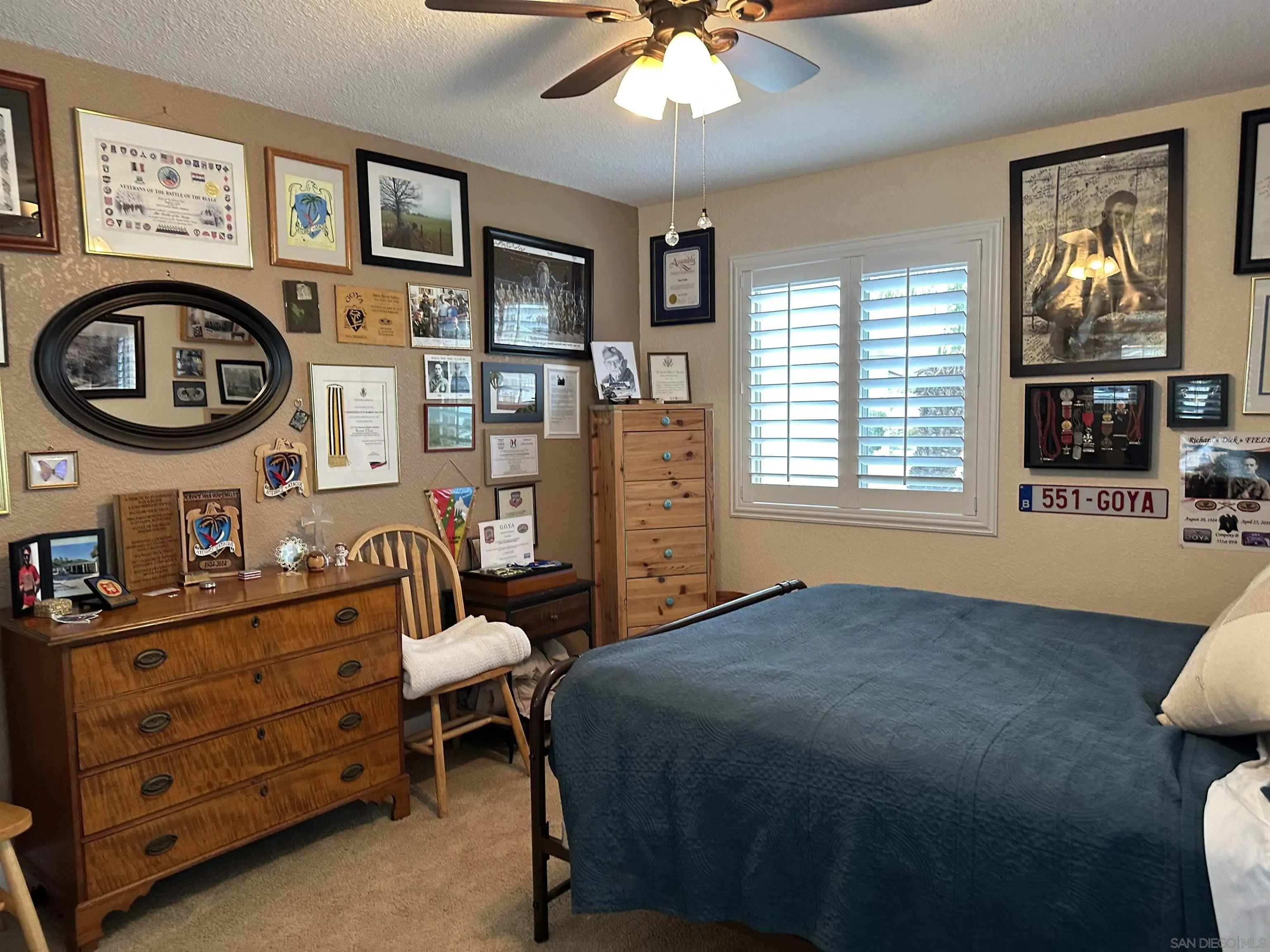 4318 Mirage Lane Oceanside, CA 92056 - Photo 15 of 17 a bedroom with a bed and a chandelier