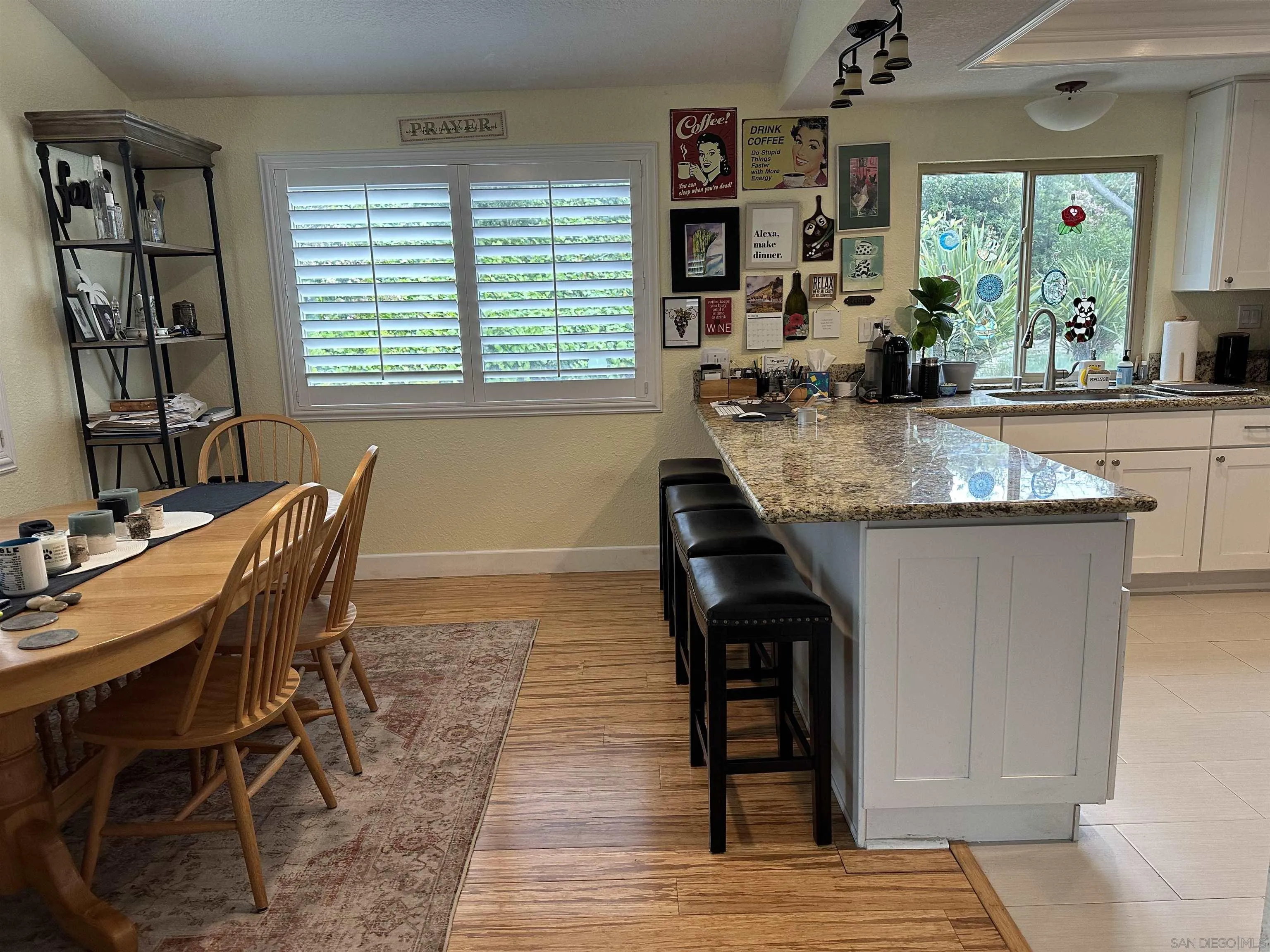 4318 Mirage Lane Oceanside, CA 92056 - Photo 4 of 17 a kitchen with granite countertop a table and chairs in it