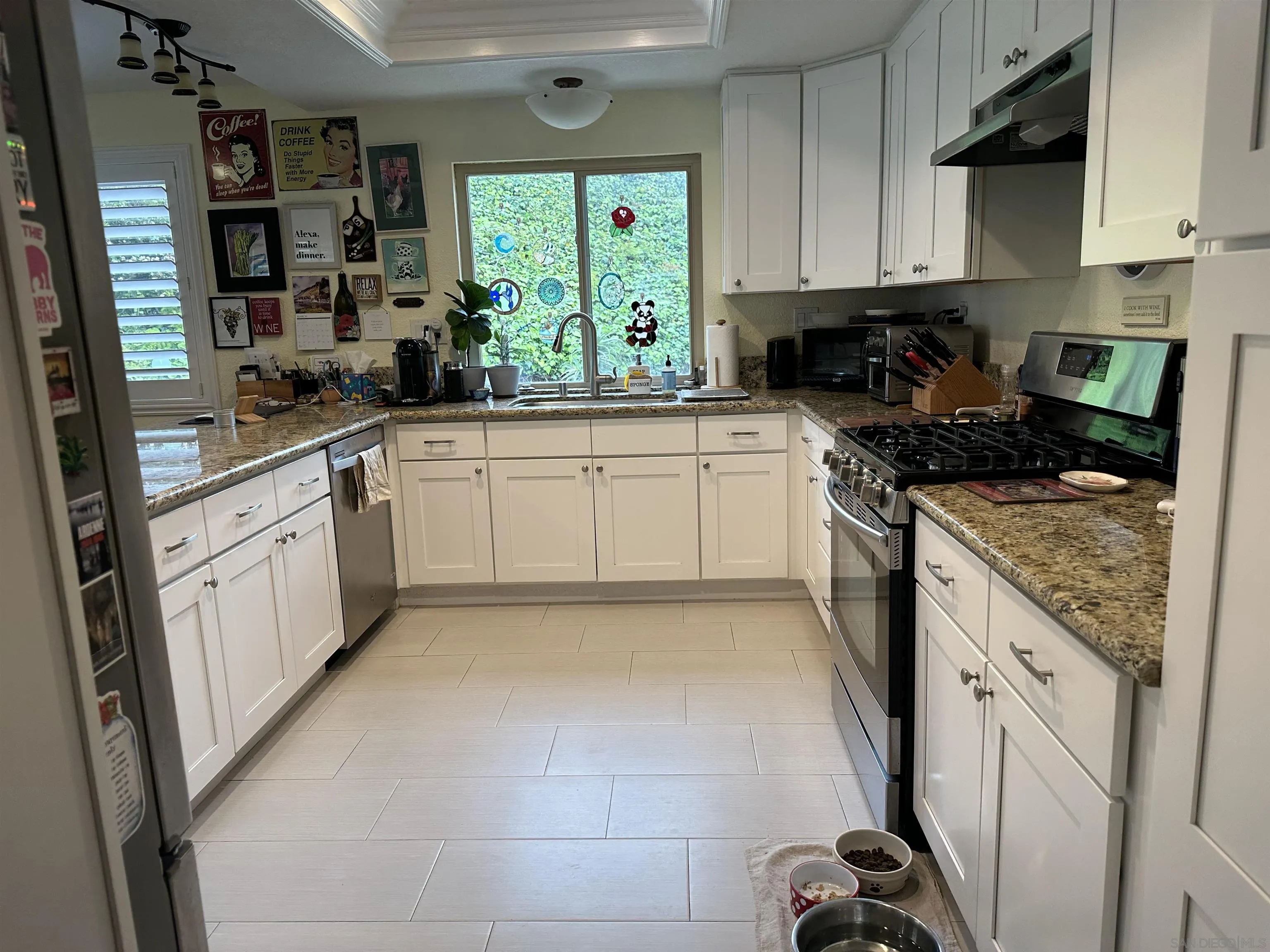 4318 Mirage Lane Oceanside, CA 92056 - Photo 5 of 17 a kitchen with a stove a sink and a refrigerator
