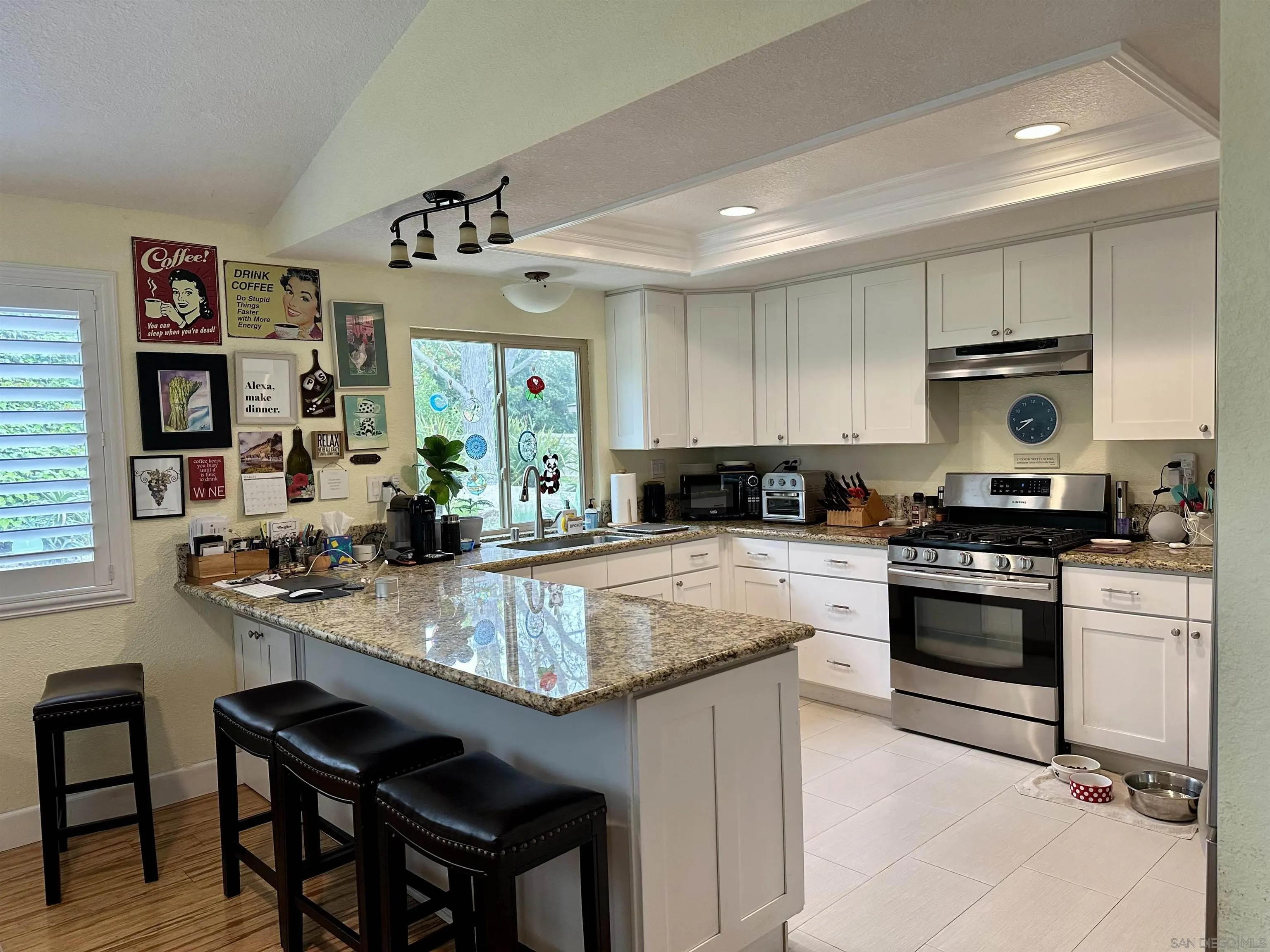 4318 Mirage Lane Oceanside, CA 92056 - Photo 6 of 17 a kitchen with kitchen island granite countertop a sink and stove