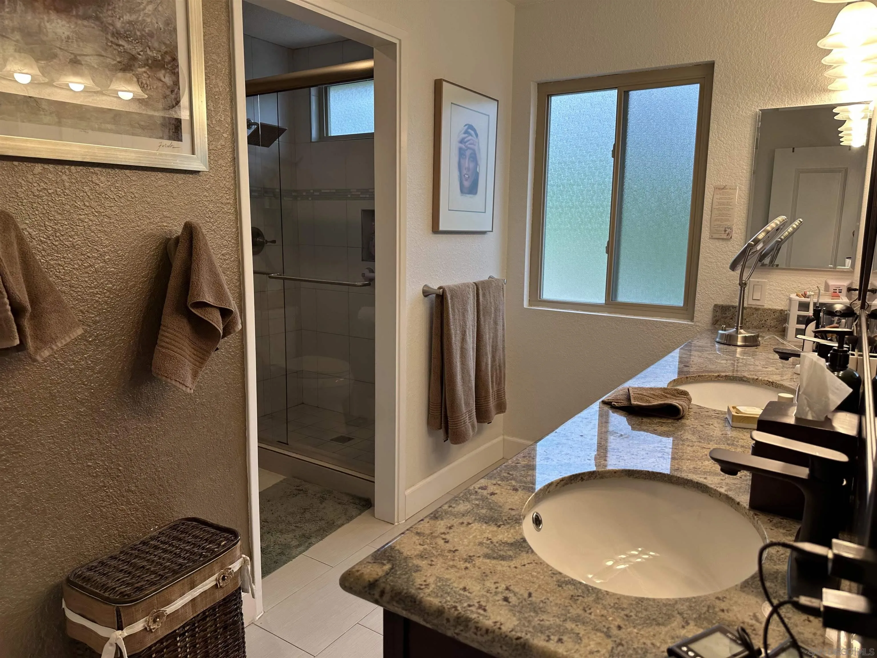 4318 Mirage Lane Oceanside, CA 92056 - Photo 10 of 17 a bathroom with a sink a toilet and a mirror