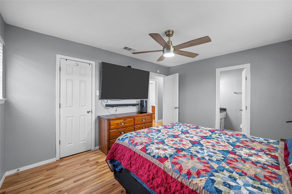 711 Rosedale Drive Hewitt, TX 76643 - Photo 12 of 16 a bedroom with a bed and a flat screen tv