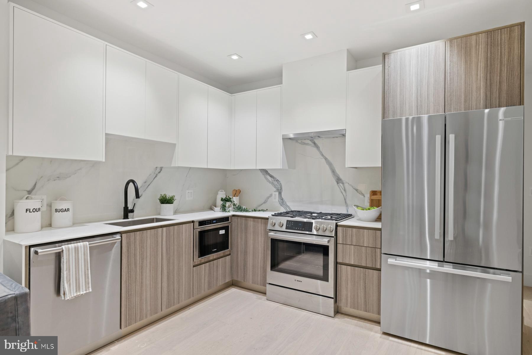 1525 P Street Northwest, Unit 1 Washington, DC 20005 - Photo 3 of 13 a kitchen with a sink stainless steel appliances and cabinets