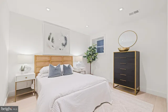 a bedroom with a bed and a potted plant