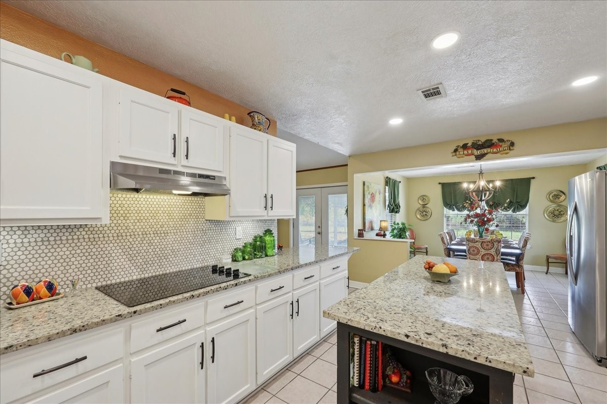 7769 Moonglow Circle Lumberton, TX 77657 - Photo 11 of 35 a kitchen with stainless steel appliances granite countertop a sink stove and cabinets
