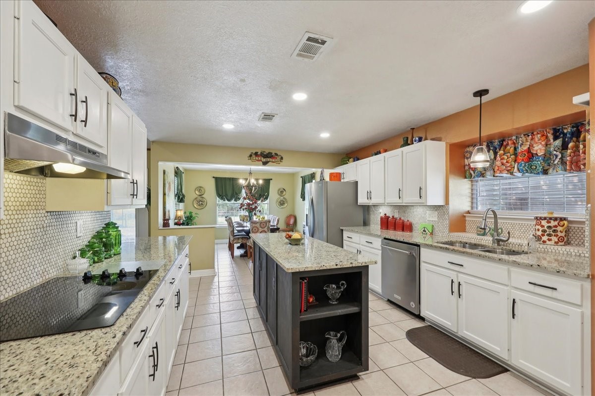 7769 Moonglow Circle Lumberton, TX 77657 - Photo 13 of 35 a kitchen with a sink and cabinets