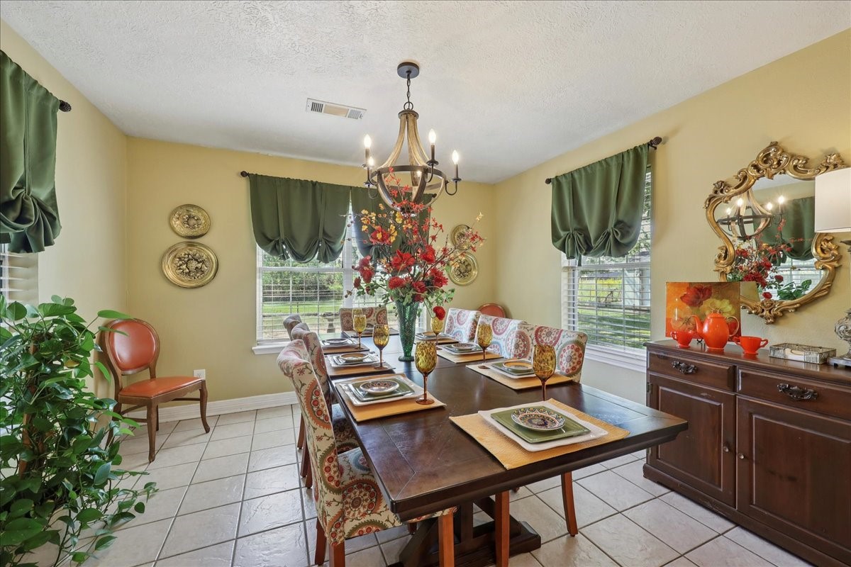 7769 Moonglow Circle Lumberton, TX 77657 - Photo 14 of 35 a view of a dining room with furniture and a chandelier