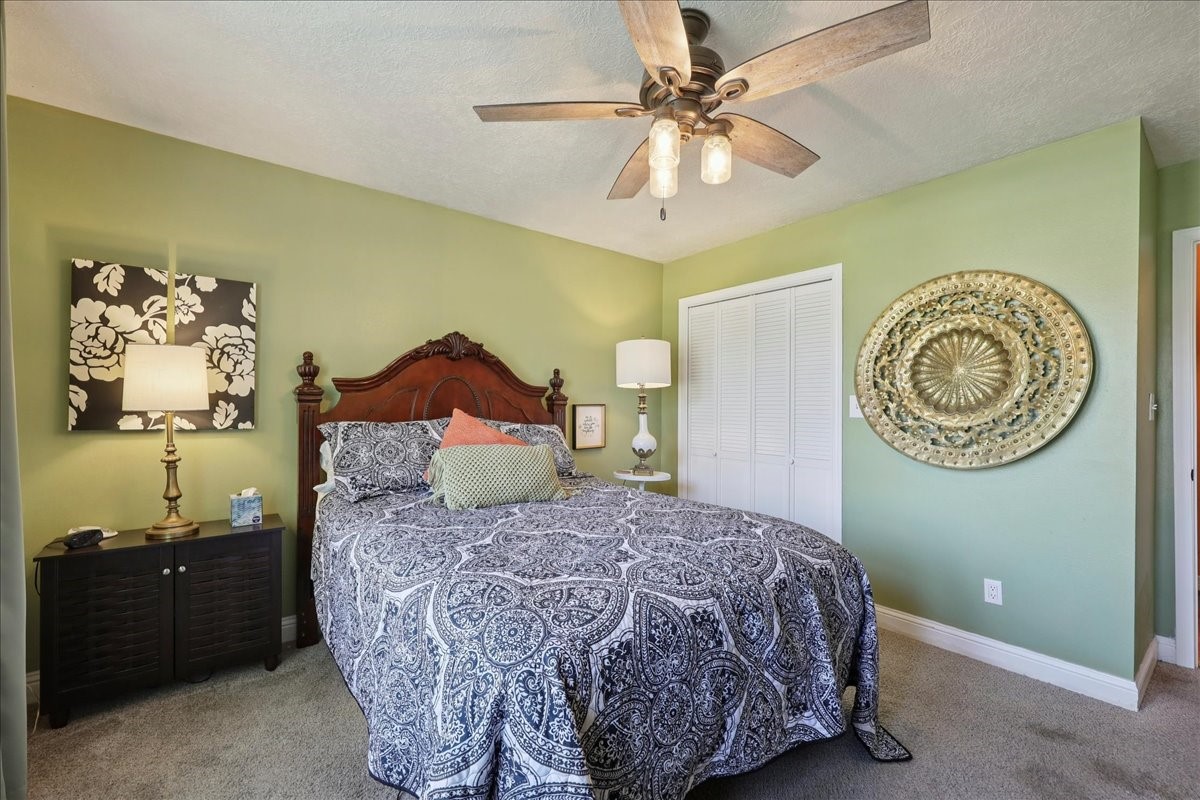 7769 Moonglow Circle Lumberton, TX 77657 - Photo 21 of 35 a bedroom with a bed and a chandelier