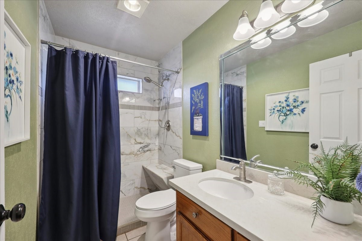 7769 Moonglow Circle Lumberton, TX 77657 - Photo 22 of 35 a bathroom with a granite countertop sink vanity mirror bathtub shower and toilet