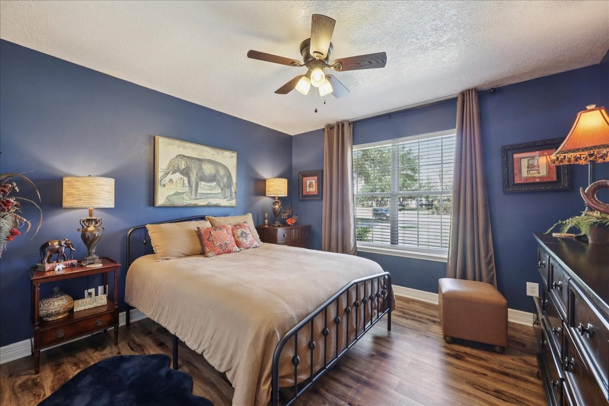 7769 Moonglow Circle Lumberton, TX 77657 - Photo 23 of 35 a bedroom with a bed and a chandelier