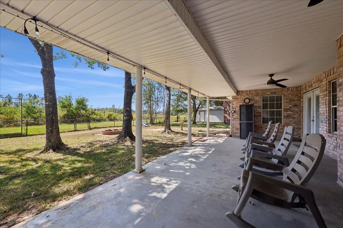 7769 Moonglow Circle Lumberton, TX 77657 - Photo 27 of 35 a view of a patio with table and chairs next to a yard