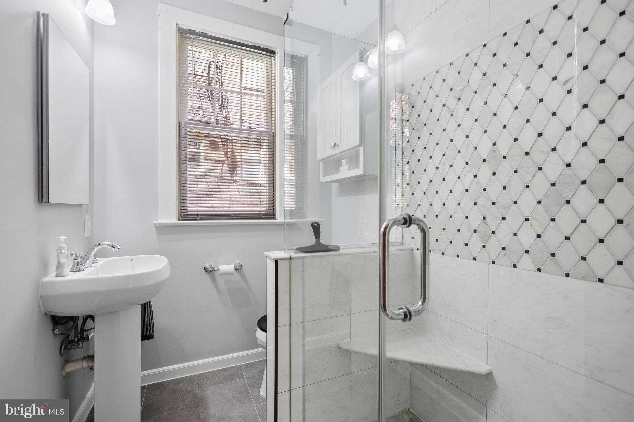 3018 Porter Street Northwest, Unit 103 Washington, DC 20008 - Photo 21 of 27 Modern bathroom with elegant tiles.