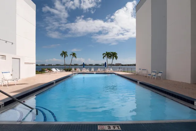 a swimming pool with outdoor seating
