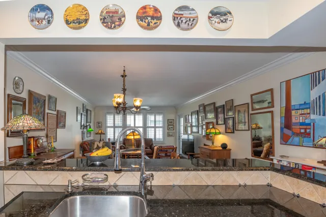 a view of a kitchen with a sink and a chandelier